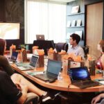 Marketing team meeting around a table reviewing digital strategy