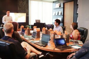 Marketing team meeting around a table reviewing digital strategy