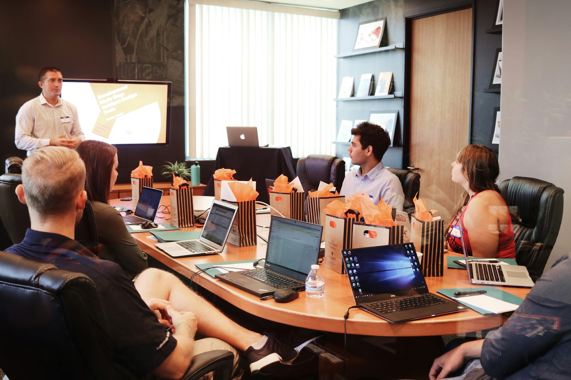 Marketing team meeting around a table reviewing digital strategy